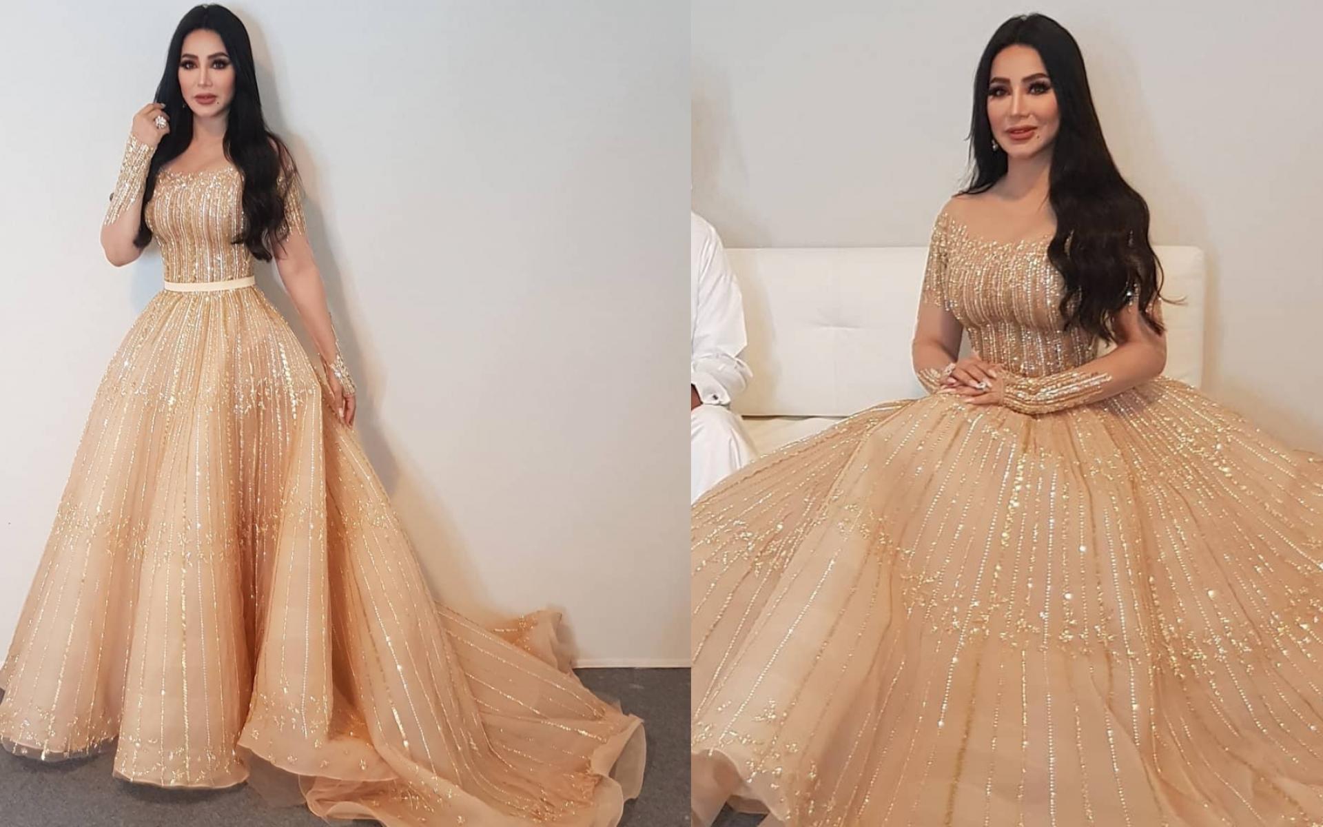 فستان باللون الذهبي وتصميم شكل الـ A الذي يتميز بحجم كبير من أسفل منطقة الخصر وصولاً للأقدام فستان باللون الذهبي وتصميم شكل الـ A الذي يتميز بحجم كبير من أسفل منطقة الخصر وصولاً للأقدام